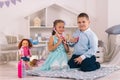 Cute boy and girl play doctor and patient, girl listens to boy`s heartbeat with stethoscope Royalty Free Stock Photo