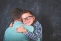 Little cute boy in glasses hug his dad. Son giving father cuddle. Happy family time. Love.