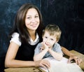 Little cute boy in glasses with young real teacher, classroom studying at blackboard school kido Royalty Free Stock Photo