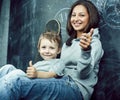 little cute boy in glasses with young real teacher, classroom studying, lifestyle people concept Royalty Free Stock Photo