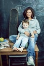 little cute boy in glasses with young real teacher, classroom studying, lifestyle people concept Royalty Free Stock Photo