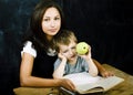 little cute boy in glasses with young real teacher, classroom studying, lifestyle people concept Royalty Free Stock Photo