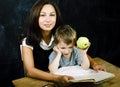 little cute boy in glasses with young real teacher, classroom studying, lifestyle people concept Royalty Free Stock Photo