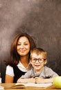 Little cute boy with young teacher in classroom studying Royalty Free Stock Photo