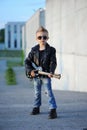 A boy like a rock star playing music on electric guitar. Royalty Free Stock Photo