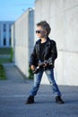 A boy like a rock star playing music on electric guitar. Royalty Free Stock Photo