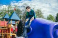 Little cute boy is having fun outdoor in summer. Playing in children zone in amusement park.