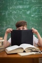 Little cute boy hiding behind book Royalty Free Stock Photo