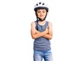 Little cute boy kid wearing bike helmet happy face smiling with crossed arms looking at the camera Royalty Free Stock Photo