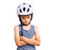 Little cute boy kid wearing bike helmet skeptic and nervous, disapproving expression on face with crossed arms Royalty Free Stock Photo