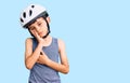 Little cute boy kid wearing bike helmet thinking looking tired and bored with depression problems with crossed arms Royalty Free Stock Photo