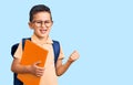 Little cute boy kid wearing school bag and holding book screaming proud, celebrating victory and success very excited with raised Royalty Free Stock Photo