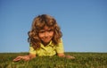 Little cute boy laying on grass. Kids exploring nature, summer.