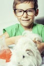 Little cute boy with medicine glass isolated wearing glasses smiling close up Royalty Free Stock Photo