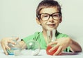 Little cute boy with medicine glass wearing glasses smiling, small genious, lifestyle people concept