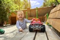 A little cute boy of one and a half years plays with toy car at the playground. Adorable toddler playing with cars and toys Royalty Free Stock Photo