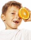 Little cute boy with orange fruit double isolated on white smiling without front teeth adorable kid cheerful Royalty Free Stock Photo