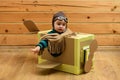 Little cute boy playing with a cardboard airplane. Royalty Free Stock Photo