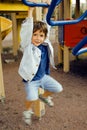 Little cute boy playing on playground, hanging on gymnastic ring Royalty Free Stock Photo