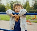 Little cute boy playing on playground, hanging on gymnastic ring Royalty Free Stock Photo