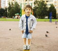 Little cute boy playing on playground, hanging on gymnastic ring Royalty Free Stock Photo