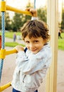 Little cute boy playing on playground, hanging on gymnastic ring Royalty Free Stock Photo