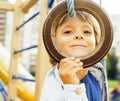 Little cute boy playing on playground, hanging on gymnastic ring Royalty Free Stock Photo