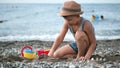 Little cute boy playing with sand using toy on beach enjoying summer travel vacation activity