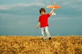 Little cute boy playing with a toy airplane. The concept of child kindness and childhood. Children run with plane on Royalty Free Stock Photo