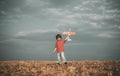 Little cute boy playing with a toy airplane. The concept of child kindness and childhood. Children run with plane on Royalty Free Stock Photo