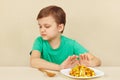 Little cute boy refuses to eat french fries Royalty Free Stock Photo