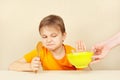 Little cute boy refuses to eat porridge Royalty Free Stock Photo