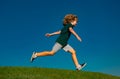 Little cute boy running on grass. Kids exploring nature, summer. Active healthy outdoor sport. Fun activity.