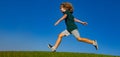 Little cute boy running on grass. Kids exploring nature, summer. Active healthy outdoor sport. Fun activity. Spring and