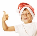 Little cute boy in santas red hat isolated thumbs