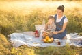 Little cute boy son and his beautiful pregnant mom at picnic Royalty Free Stock Photo