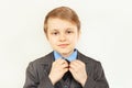 Little cute boy straighten collar of elegant suit Royalty Free Stock Photo