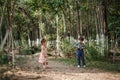 A little cute boy in vintage clothes and a little beautiful girl in a retro dress are walking in the woods and taking pictures. Royalty Free Stock Photo