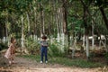 A little cute boy in vintage clothes and a little beautiful girl in a retro dress are walking in the woods and taking pictures. Royalty Free Stock Photo