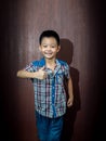 Little cute boy on wood background Royalty Free Stock Photo