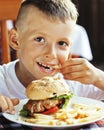 little cute boy 6 years old with hamburger and french fries maki Royalty Free Stock Photo