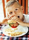 little cute boy 6 years old with hamburger and french fries maki Royalty Free Stock Photo