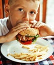 little cute boy 6 years old with hamburger and french fries maki Royalty Free Stock Photo