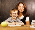 Little cute boy with young teacher in classroom Royalty Free Stock Photo