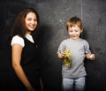 little cute boy with young teacher in classroom studying at blac Royalty Free Stock Photo
