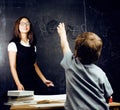 little cute boy with young teacher in classroom studying, lifest Royalty Free Stock Photo