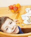 Little cute boys eating dessert on wooden kitchen. home interior. smiling adorable friendship together forever friends Royalty Free Stock Photo