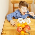 Little cute boys eating dessert on wooden kitchen. home interior. smiling adorable friendship together forever friends Royalty Free Stock Photo