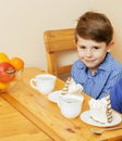 Little cute boys eating dessert on wooden kitchen. home interior. smiling adorable friendship together forever friends Royalty Free Stock Photo