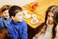 Little cute boys eating dessert on wooden kitchen. home interior. smiling adorable friendship together forever friends Royalty Free Stock Photo